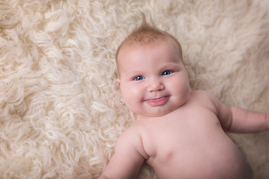 Baby girl making silly face during portrait session