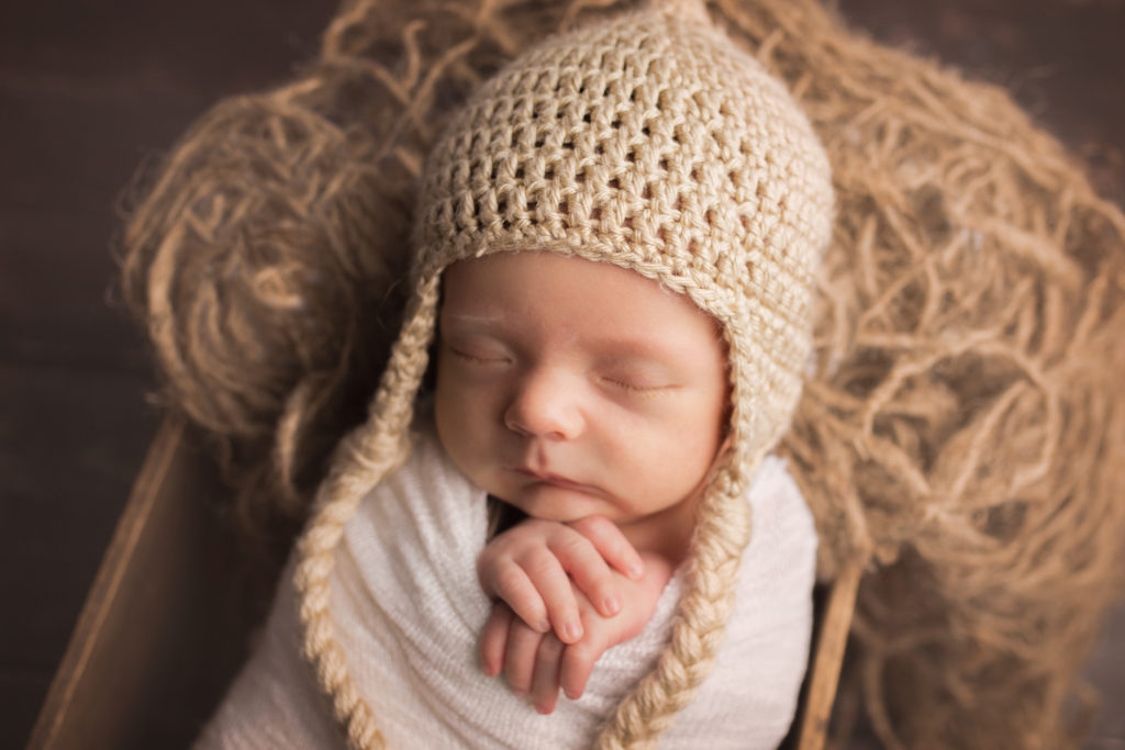 Sleeping colorado newborn in knit hat