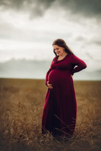 pregnant woman in front of rocky mountains